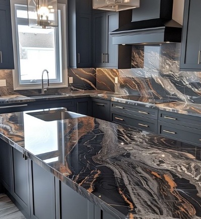 We put in dark marble counters and a matching backsplash. We paired them with new navy cabinets.
