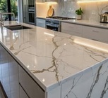 We installed white marble counters on the island. The stone runs down the sides for a clean, modern look.