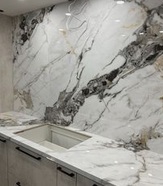 We installed a full marble slab wall with a matching counter. We also added a new built-in sink.